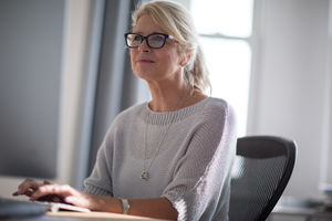 Mature businesswoman typing on keyboard