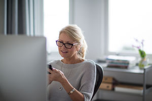 Mature businesswoman using smartphone