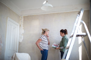 Mature female friends choosing paint colors