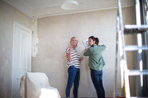 Mature female friends choosing paint colors