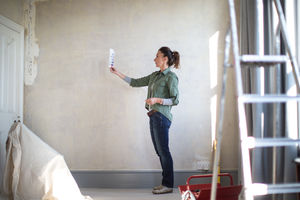 Mature female choosing paint colors