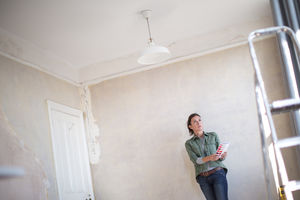 Mature female choosing paint colors