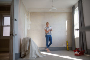 Mature female choosing paint colors