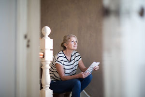 Mature female choosing paint colors