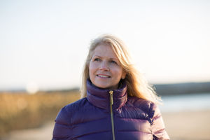 Mature female enjoying the outdoors in winter on the beach