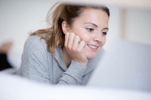 Young adult female reading in bed