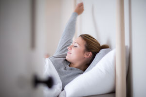 Young adult female waking up in the morning