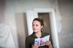 Young adult female choosing paint colors