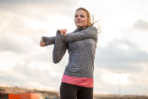 Young adult female stretching before a run