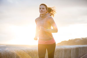 Young adult female running outdoors