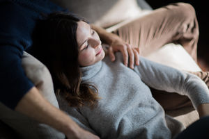 Couple relaxing on sofa together