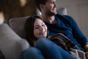 Couple relaxing on sofa together