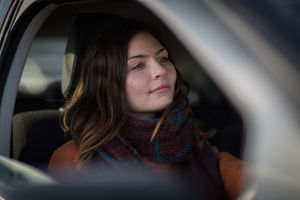 Young adult female driving car