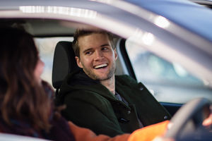 Passenger smiling at driver