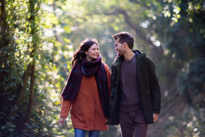 Couple having a walk in forest in autumn