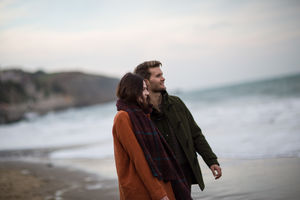 Young adult couple walking on beach