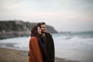 Young adult couple walking on beach