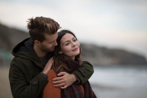Young adult couple hugging on beach