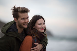 Young adult couple hugging on beach