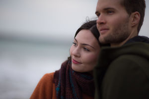 Young adult couple on winter beach