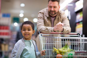 Father and son doing weekly shop in grocery store