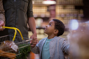 Mother and son doing weekly shop in grocery store