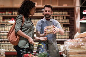 Baker helping customer in grocery store