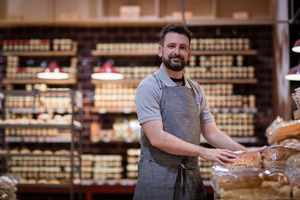 Baker in bakery looking to camera