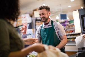 Woman at grocery checkout scan