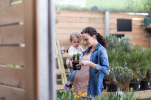 Pregnant mother with daughter at garden centre