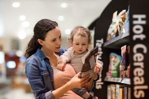 Pregnant mother with daughter grocery shopping