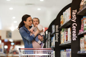 Pregnant mother with daughter grocery shopping