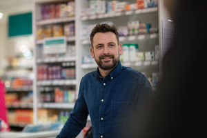 Pharmacist serving customer