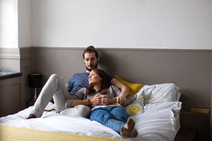 Young couple having coffee in bed