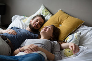 Young couple relaxing in bed