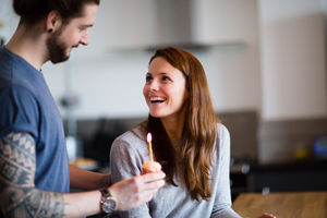 Boyfriend giving girlfriend a birthday cupcake