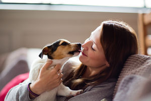 Young female with puppy at home