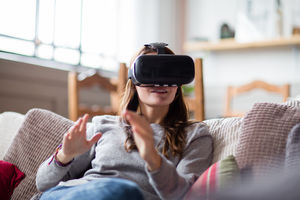 Young adult female using VR headset
