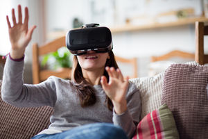 Young adult female using VR headset