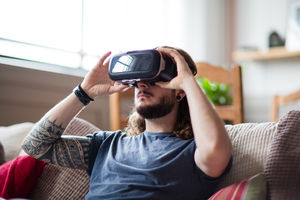 Young adult male using VR headset