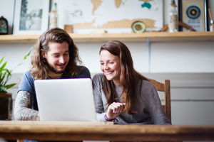 Young adult couple using a laptop together