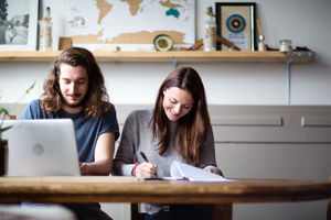 Young adult couple using a working on finance application together