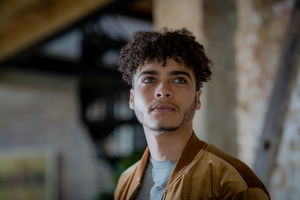 Multiracial young adult male looking to future