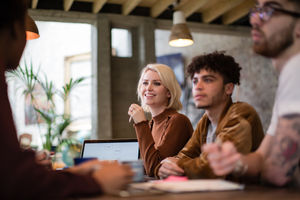 Group of young entrepreneurs listening to a presentation