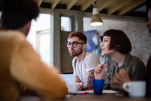 Group of young entrepreneurs listening to a presentation