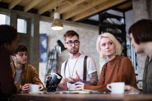 Group of young entrepreneurs in a meeting with VR headset