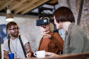 Group of young entrepreneurs in a meeting with VR headset