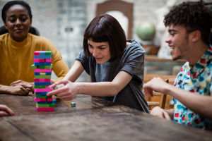 Group of friends playing retro game in pub