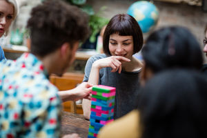 Group of friends playing retro game in pub