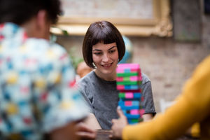 Group of friends playing retro game in pub